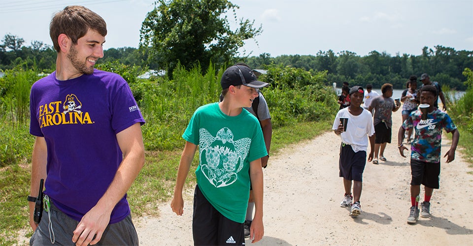 Nutrition Science student and camp counselor Jared Lowe leads a group of campers during a mile-long hike as part of the Love A Sea Turtle program’s education efforts. (Photos by Cliff Hollis)