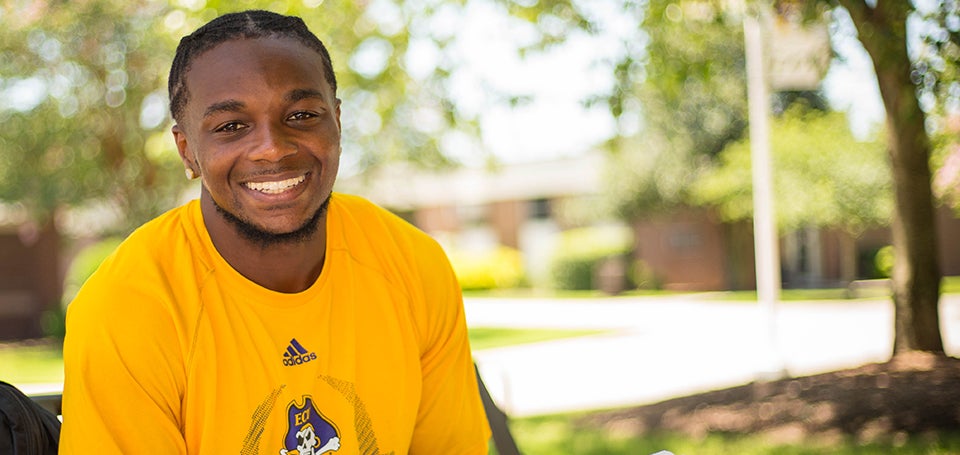 East Carolina University football player Jeffrey Coprich honors his sister’s memory through the Essence K. Coprich library and book club. (Photos by Cliff Hollis)