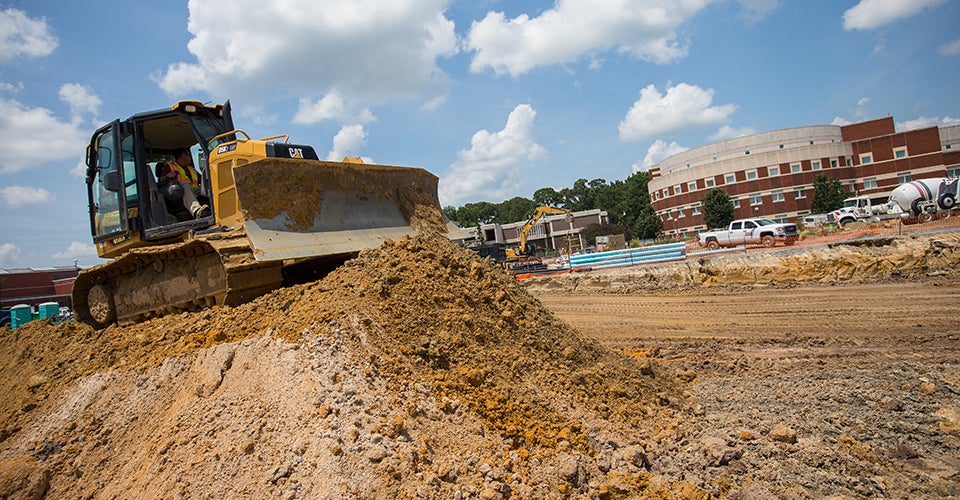 Before the new student center on main campus can go up, vital underground utilities must be laid down, like power, water, storm water, sewer and communication lines. (Photos by Cliff Hollis)