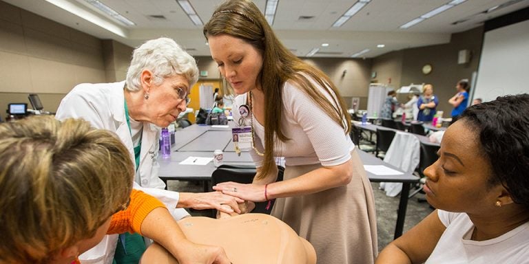 Left to right, Renee Spain, Monica Newby, Jennifer Osborne and Ashley Holt work on hand maneuvers during delivery. (Photos by Cliff Hollis)