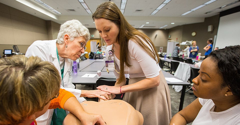 Left to right, Renee Spain, Monica Newby, Jennifer Osborne and Ashley Holt work on hand maneuvers during delivery. (Photos by Cliff Hollis)