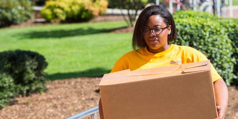 First-generation student Tierra Perry helps at Garrett Hall. She's enrolled in the Anchors Living-Learning Community, designed to help students who are the first in their families to attend college. (Photos by Cliff Hollis)