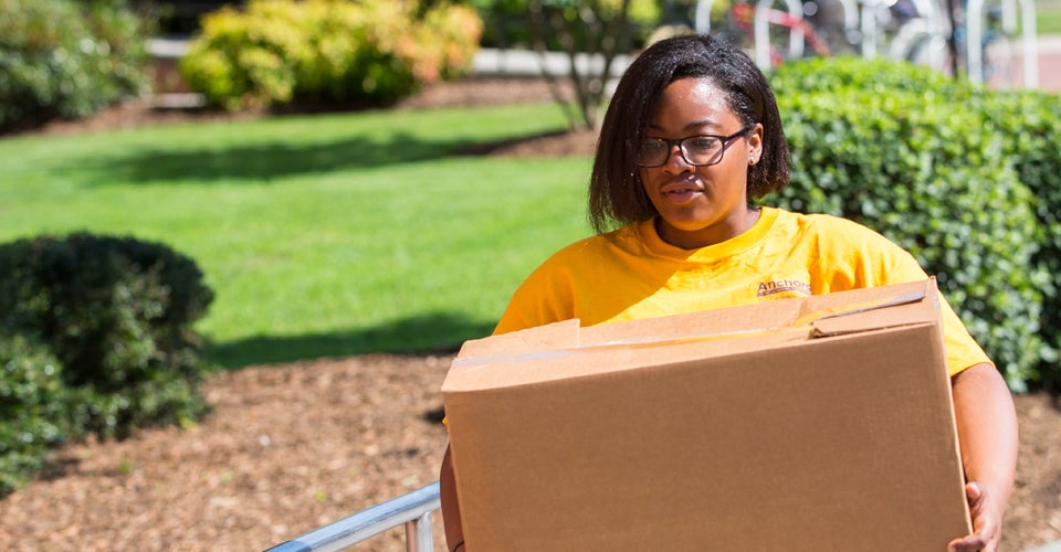 First-generation student Tierra Perry helps at Garrett Hall. She's enrolled in the Anchors Living-Learning Community, designed to help students who are the first in their families to attend college. (Photos by Cliff Hollis)