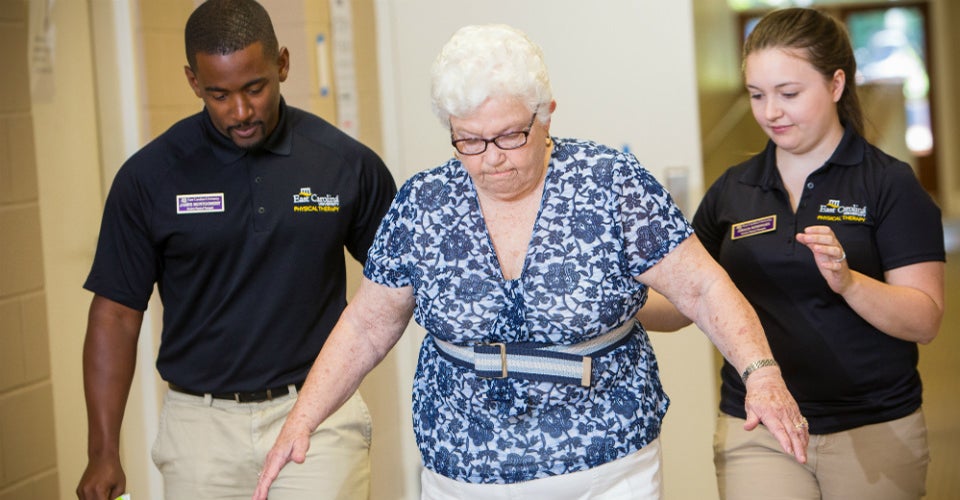 Physical therapy students James Montgomery and Amalia Kondyles guide Annie May through a fall risk assessment at Black Jack Original Free Will Baptist Church in June. Students and faculty from occupational therapy and physician assistant studies also participated in the day-long clinic. (Photos by Cliff Hollis)