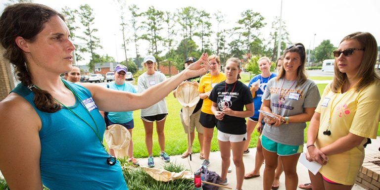 Melissa Dowland, coordinator of teacher education at the N.C. Museum of Natural Sciences, shows teachers an abandoned mud dauber nest found outside Eastern Elementary School in Greenville. (Photos by Cliff Hollis)