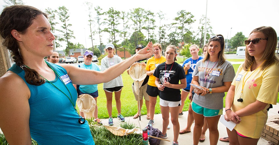 Melissa Dowland, coordinator of teacher education at the N.C. Museum of Natural Sciences, shows teachers an abandoned mud dauber nest found outside Eastern Elementary School in Greenville. (Photos by Cliff Hollis)