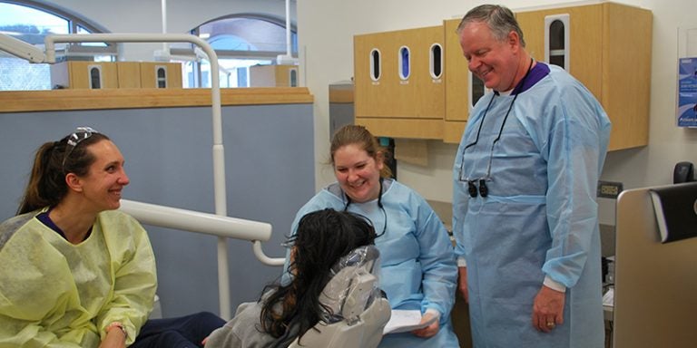 Nursing student Brittany Box, dental student Nikki Harrold, and Dr. Linc Conn, chair of ECU’s Department of General Dentistry, chat with a patient after completing her dental work at ECU Smiles. (Contributed photos)