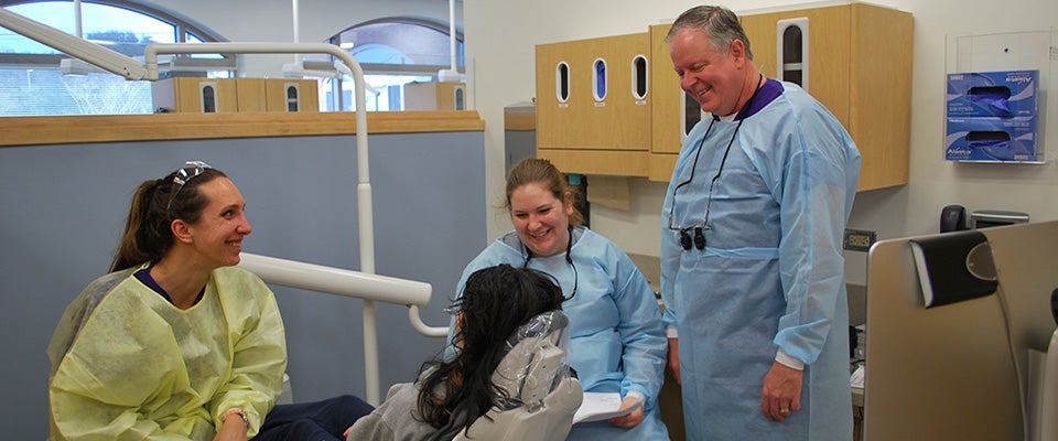 Nursing student Brittany Box, dental student Nikki Harrold, and Dr. Linc Conn, chair of ECU’s Department of General Dentistry, chat with a patient after completing her dental work at ECU Smiles. (Contributed photos)