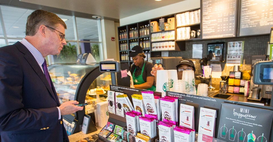 ECU’s 11th chancellor, Dr. Cecil Staton, orders a morning coffee before beginning his first day on the job. (Photos by Cliff Hollis)