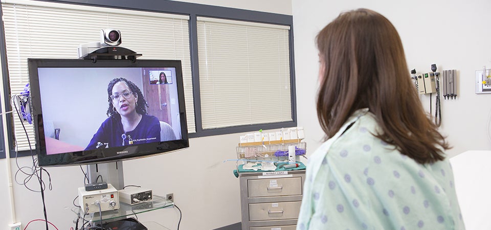 With the use of telepsychiatry, Brody School of Medicine psychiatrists like Dr. Toni Johnson (on screen) can connect with patients in hospital emergency departments statewide. (Photos by Cliff Hollis)