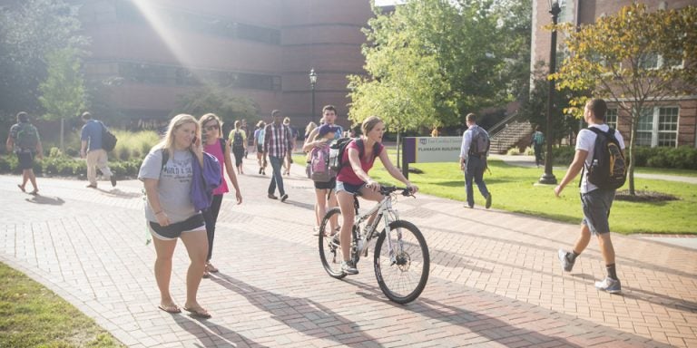 A picture of students walking outside of the flannagan building.