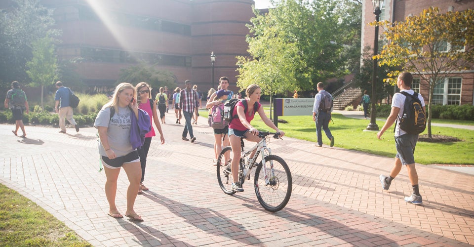 A picture of students walking outside of the flannagan building.