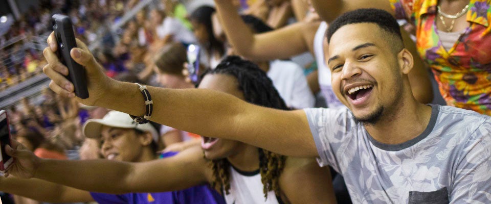 ECU freshman Michael Holland and friends enjoy a pep rally during the 16th annual Student Welcome and Convocation at Minges Coliseum Aug. 21. (Photos by Cliff Hollis)