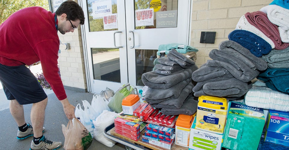 Brody School of Medicine student Richard Jordan drops off a donation outside the school on Tuesday. (Photos by Cliff Hollis)