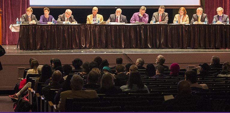 ECU student Jay Garcia, standing at lower left, speaks to members of the ECU Board of Trustees, who listened to opinions on the proposed renaming of Aycock Residence Hall during the first of two public forums Jan. 26. The second forum is set for Jan. 27 on the Health Sciences campus. (Photos by Cliff Hollis)