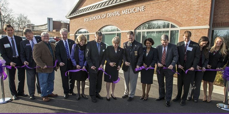 Officials from ECU and Davidson County join in the ribbon cutting ceremony for the ECU School of Dental Medicine community service learning center Dec. 15. (Photos by Cliff Hollis)