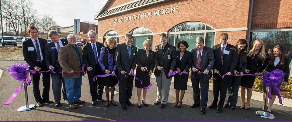 Officials from ECU and Davidson County join in the ribbon cutting ceremony for the ECU School of Dental Medicine community service learning center Dec. 15. (Photos by Cliff Hollis)