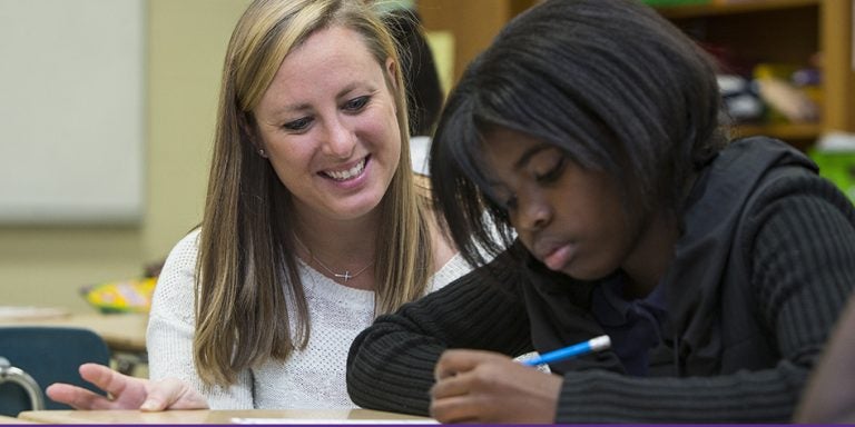 Eppes Middle School teacher Kirsten Coleman, left, works with Aujahanna Davis at C.M. Eppes Middle School in Greenville. Coleman is part of a collaboration with ECU to support new teachers. (Photos by Cliff Hollis)