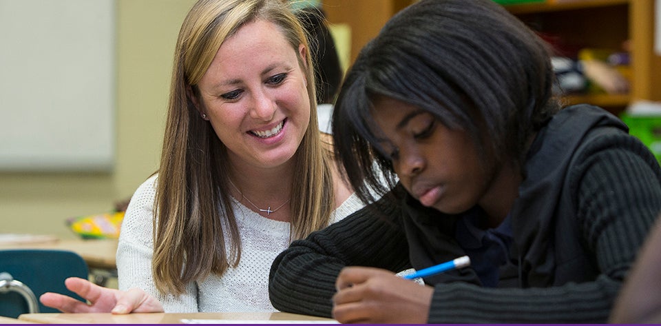 Eppes Middle School teacher Kirsten Coleman, left, works with Aujahanna Davis at C.M. Eppes Middle School in Greenville. Coleman is part of a collaboration with ECU to support new teachers. (Photos by Cliff Hollis)