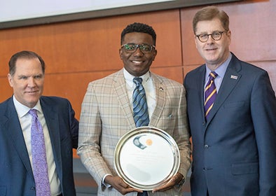 La’Quon Rogers, SGA president, was recognized for his service as an ex oficio member of the ECU Board of Trustees by board chair Kieran Shanahan, left, and Chancellor Cecil Staton.