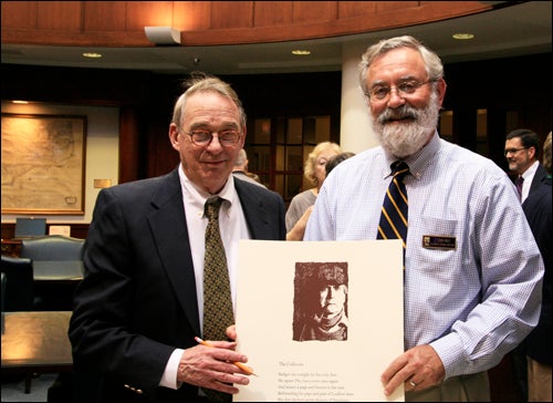 Former North Carolina Poet Laureate Fred Chappell signs limited edition broadside for Special Collections Curator Jonathan Dembo. (Contributed photo)