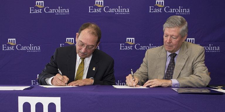 UNC Pembroke Chancellor Kyle Carter and East Carolina University Chancellor Steve Ballard sign a memorandum of understanding that will establish a satellite program for ECU's doctorate in physical therapy at UNCP. The agreement aims to prepare more physical therapists for eastern North Carolina. (Photos by Cliff Hollis)