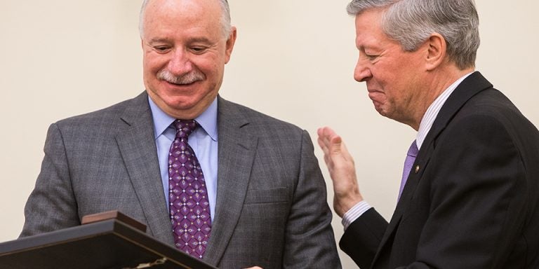 Chancellor Steve Ballard, right, recognizes outgoing board chairman Robert Brinkley during the April 24 meeting of the ECU Board of Trustees. Brinkley served on the board for eight years. (Photos by Cliff Hollis)