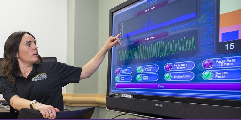 ECU doctoral student Christina Brown-Bochicchio shares details on how biofeedback can help wounded warriors during the March 20 opening of ECU's Center for Applied Psychophysiology. (Photos by Cliff Hollis)