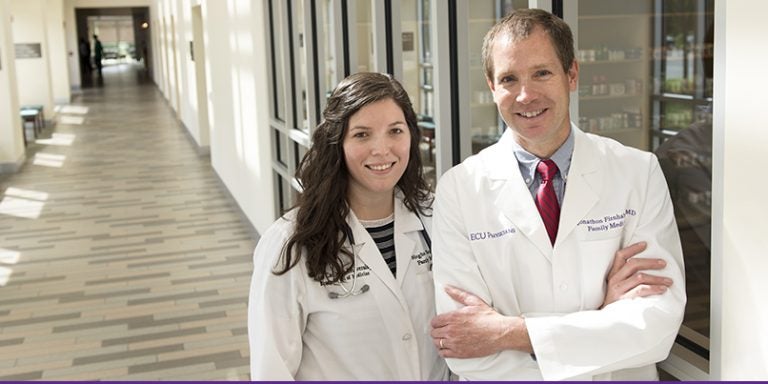 At left, Dr. Meghan Scott, a Brody School of Medicine graduate and second-year family medicine resident at ECU, stands with Dr. Jonathon Firnhaber, ECU's family medicine residency program director. ECU has again been ranked as among the top ten in the nation in producing family care physicians. (Photo by Gretchen Baugh)