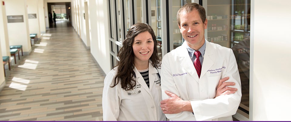 At left, Dr. Meghan Scott, a Brody School of Medicine graduate and second-year family medicine resident at ECU, stands with Dr. Jonathon Firnhaber, ECU's family medicine residency program director. ECU has again been ranked as among the top ten in the nation in producing family care physicians. (Photo by Gretchen Baugh)