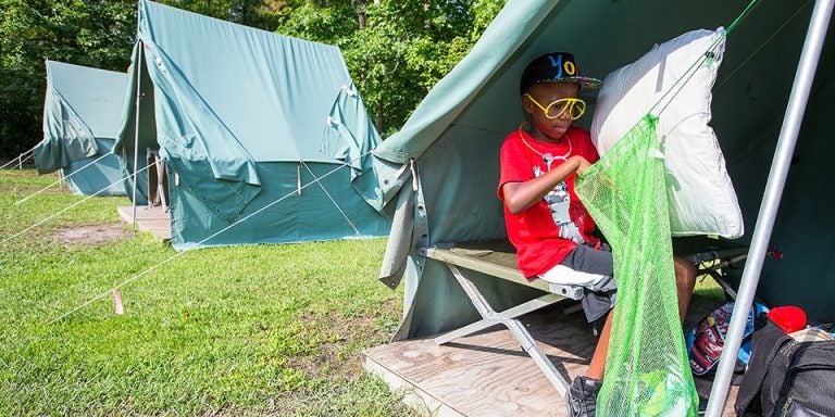 Camp Needles in the Pines participant Dylan Simpson packs his gear in preparation for leaving on the final day of camp. The one-week camp offered each summer by the Department of Pediatrics in the Brody School of Medicine helps children learn strategies for coping with their Type 1 Diabetes. (Photos by Cliff Hollis)