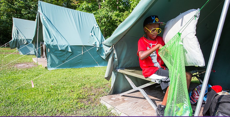 Camp Needles in the Pines participant Dylan Simpson packs his gear in preparation for leaving on the final day of camp. The one-week camp offered each summer by the Department of Pediatrics in the Brody School of Medicine helps children learn strategies for coping with their Type 1 Diabetes. (Photos by Cliff Hollis)