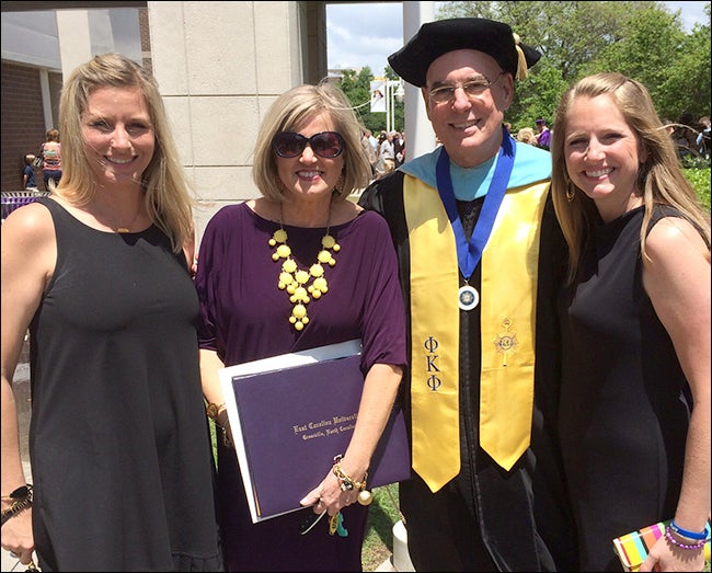 With College of Engineering and Technology Dean Dr. David White, second from right, at the college commencement ceremony are Amy Lyerly, Nancy Lee and Paige MacGovern. Lee is the wife of Robert Lee Jr, who died just short of earning his bachelor's degree at ECU. Along with daughters Lyerly and MacGovern, she accepted a posthumous degree in his honor.