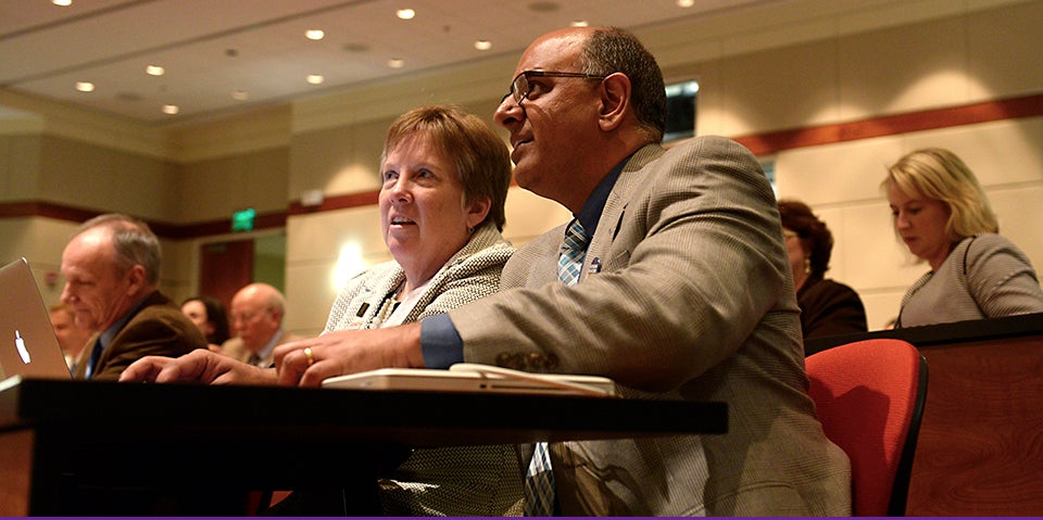 At the first Medical Education Day at ECU, Dr. Elizabeth Baxley, senior associate dean for academic affairs at the Brody School of Medicine, left, speaks with keynote speaker Dr. Rajesh Mangrulkar, associate dean for medical school education at the University of Michigan. ECU and the University of Michigan are among 11 schools selected nationwide to reshape medical education. (Photos by Gretchen Baugh)