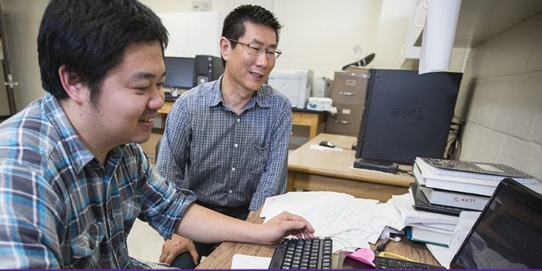 ECU biology professor Jinling Huang, right, is one of three East Carolina University faculty members to be recognized for excellence during Research and Creative Achievement Week. He will be honored for five-year achievement along with management information systems professor Huigang Liang. John Shearin, School of Theatre and Dance, will be recognized with the Lifetime Achievement Award. (Photos by Cliff Hollis)