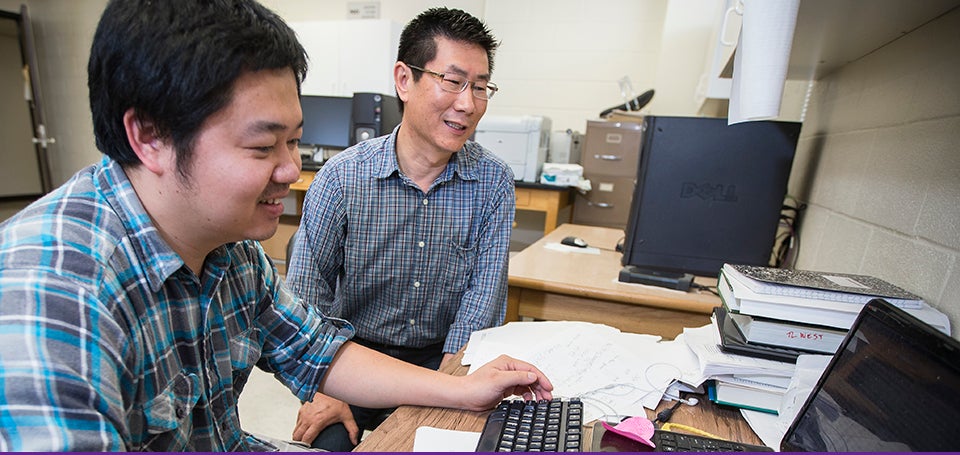 ECU biology professor Jinling Huang, right, is one of three East Carolina University faculty members to be recognized for excellence during Research and Creative Achievement Week. He will be honored for five-year achievement along with management information systems professor Huigang Liang. John Shearin, School of Theatre and Dance, will be recognized with the Lifetime Achievement Award. (Photos by Cliff Hollis)