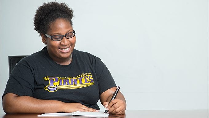 ECU student and STEPP Program Mentor Alysha Gray demonstrates the Livescribe smartpen, which helps students with learning disabilities take notes in class. (Photos by Cliff Hollis)