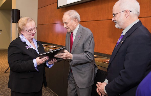 Dr. Diana Bond accepts the Max Ray Joyner Award for Outstanding Teaching in Distance Education from Max Joyner and Dr. John Stiller, chair of Faculty Senate.
