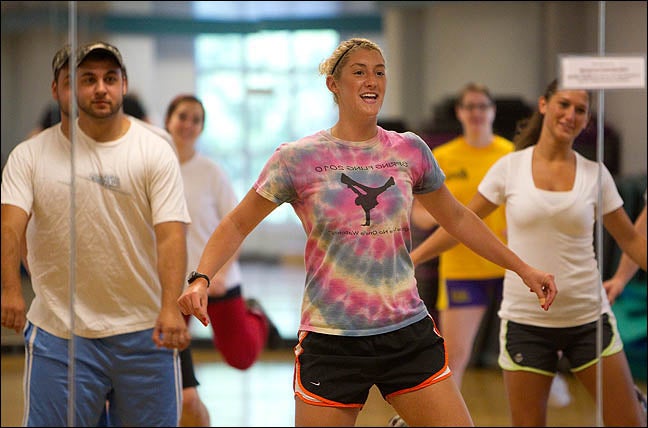 Instructor Courtney Frueauf, center, leads a class in aerobics. While many universities are eliminating required exercise courses from the curriculum, ECU is maintaining the requirement. (Photos by Cliff Hollis)