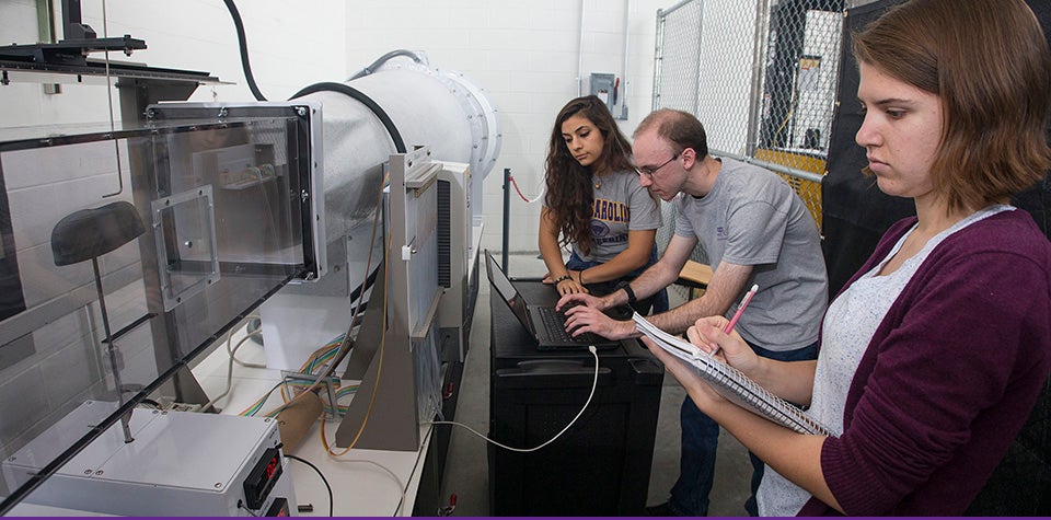 ECU engineering students Hanadee Abu-Zayed, Nicholas Garcia and Carrie Robinson, left to right, conduct experiments using the wind tunnel on campus. (Photos by Jay Clark)