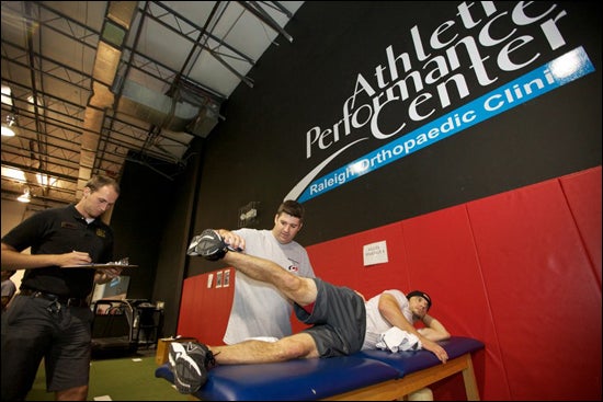 ECU clinical assistant professor Kevin Youngs and student F.J. Goodwin evaluates players competing for a spot with the Carolina Hurricanes hockey team. (Photos by Cliff Hollis)