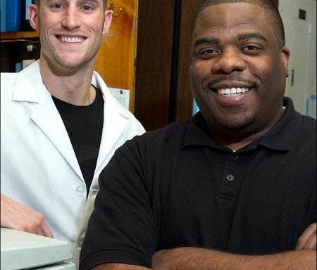 William Chappell, left, and Ossie Dyson completed their doctorates in microbiology and immunology this fall at the Brody School of Medicine at ECU. (Photo by Cliff Hollis)