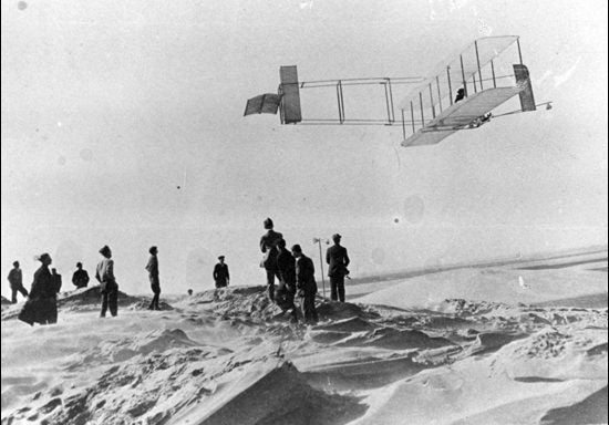 A 1911 image from a Wright brothers' flight at Kill Devil Hills shows a crowd of observers and reporters viewing the event. (Photo courtesy of ECU Joyner Library Digital Images Collection)