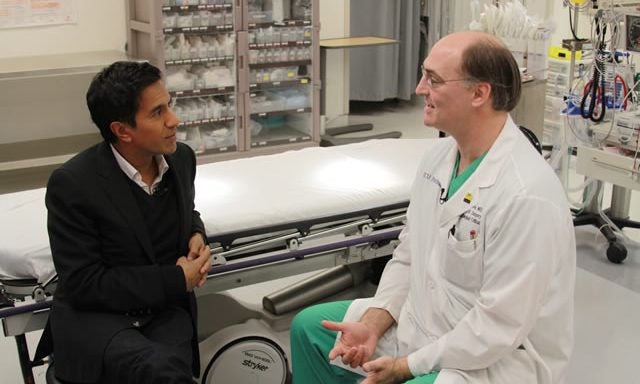 CNN's Dr. Sanjay Gupta, left, speaks with ECU trauma surgeon Dr. Scott Sagraves on Saturday, Oct. 15, at Pitt County Memorial Hospital about the 2008 death of high school football player Jaquan Waller following a head injury. Photo by Doug Boyd