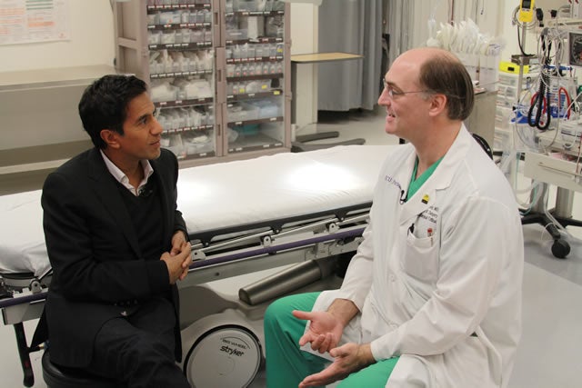 CNN's Dr. Sanjay Gupta, left, speaks with ECU trauma surgeon Dr. Scott Sagraves on Saturday, Oct. 15, at Pitt County Memorial Hospital about the 2008 death of high school football player Jaquan Waller following a head injury. Photo by Doug Boyd