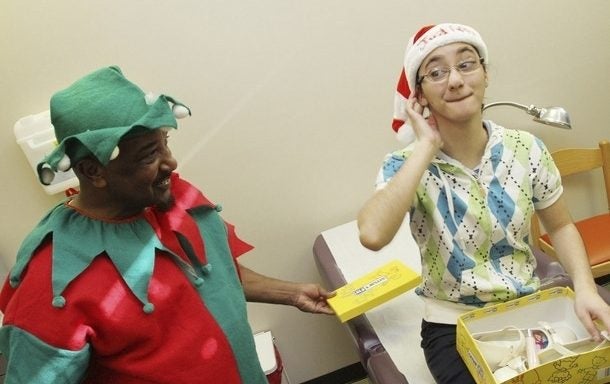 ENCSD student Judith Urias likes her new dancing shoes as ECU employee Johnny Stanley watches. Photo by Gray Whitley, Wilson Daily Times