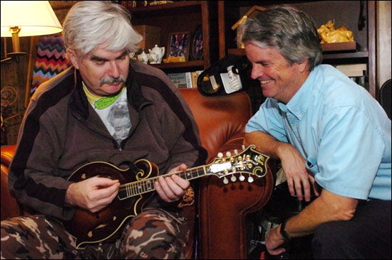 Dr. Bobby Jones, left, plays mandolin as his brother, Dr. Stephen Jones listens at Bobby Jones' home in Shelby. (Photo by Doug Boyd)