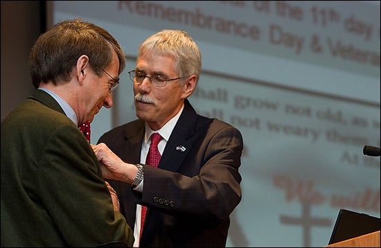 Dr. Stephen Thomas, right, dean of College of Allied Health Sciences, presents keynote speaker Dr. John Gilbert with a pin from the college. (Photo by Cliff Hollis)