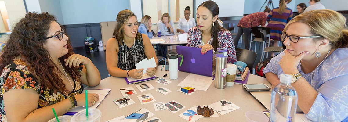 Members of the first CONVEY cohort, from left, Chelsea Forest, Alexis Newman, Sarah Risley, and Tracie Marshburn, work on a group project during the summer institute at the ECU Health Sciences Student Center. 