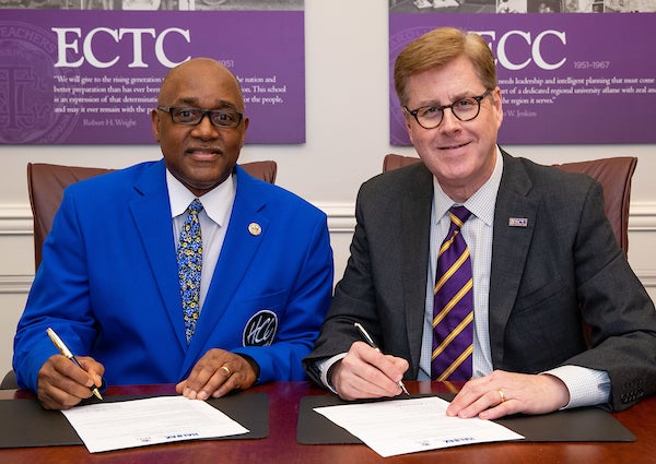 Dr. Michael Elam, left, president of Halifax Community College, and ECU Chancellor Cecil Staton signed a co-admission agreement between the two institutions.
